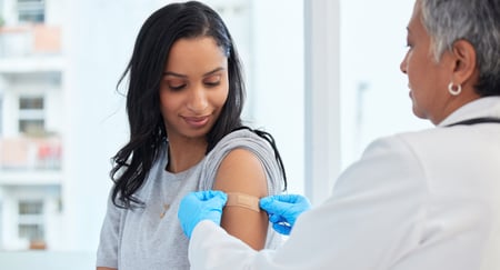 woman receiving vaccination shot