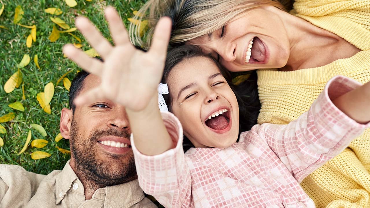 Overhead view of a happy family spending time together in the park.